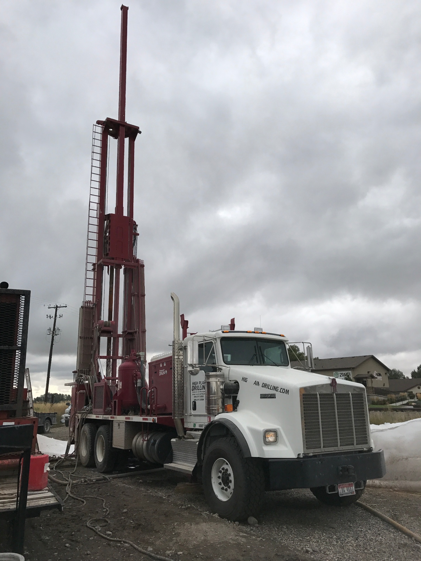 High Plains Drilling truck with red rig on site